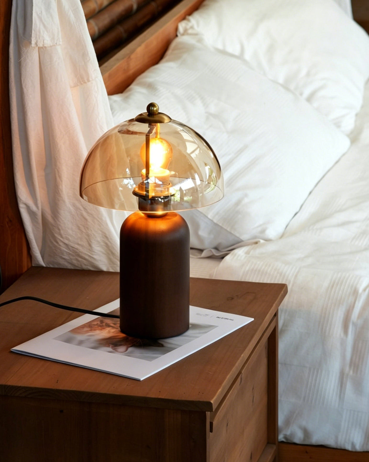 Detail shot of the cylindrical walnut wood base and brushed metal collar.