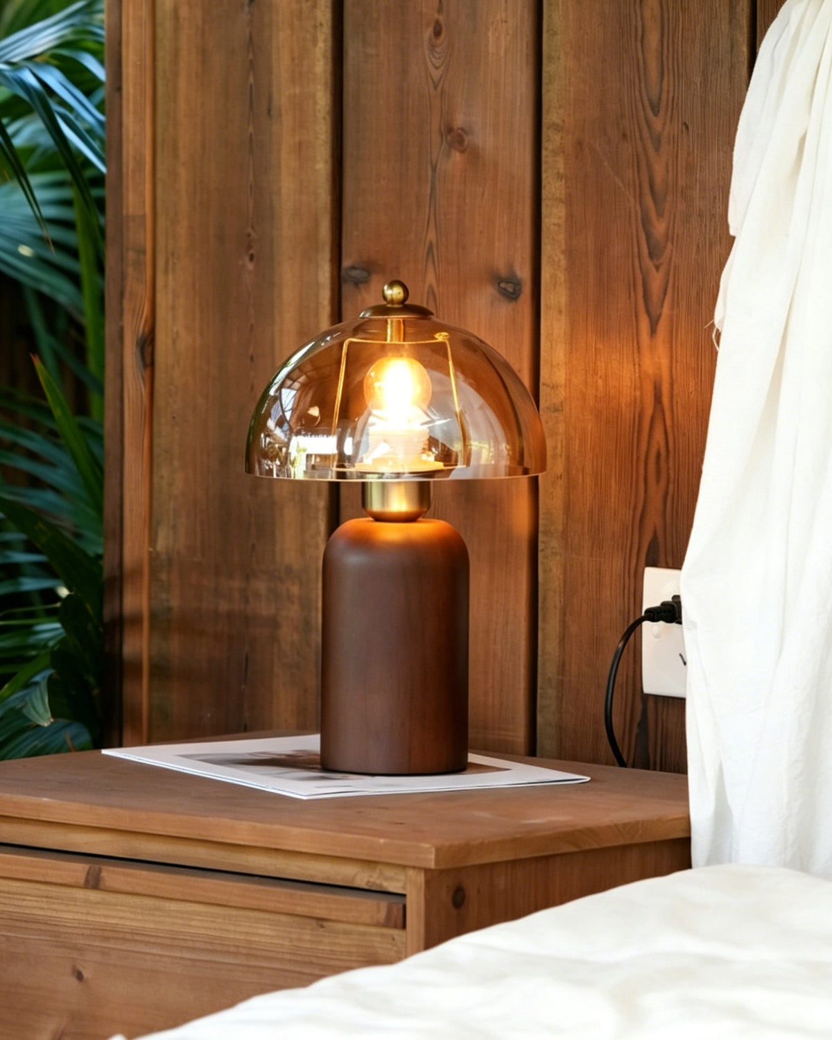 The Disko Table Lamp placed in a living room setting on a side table.
