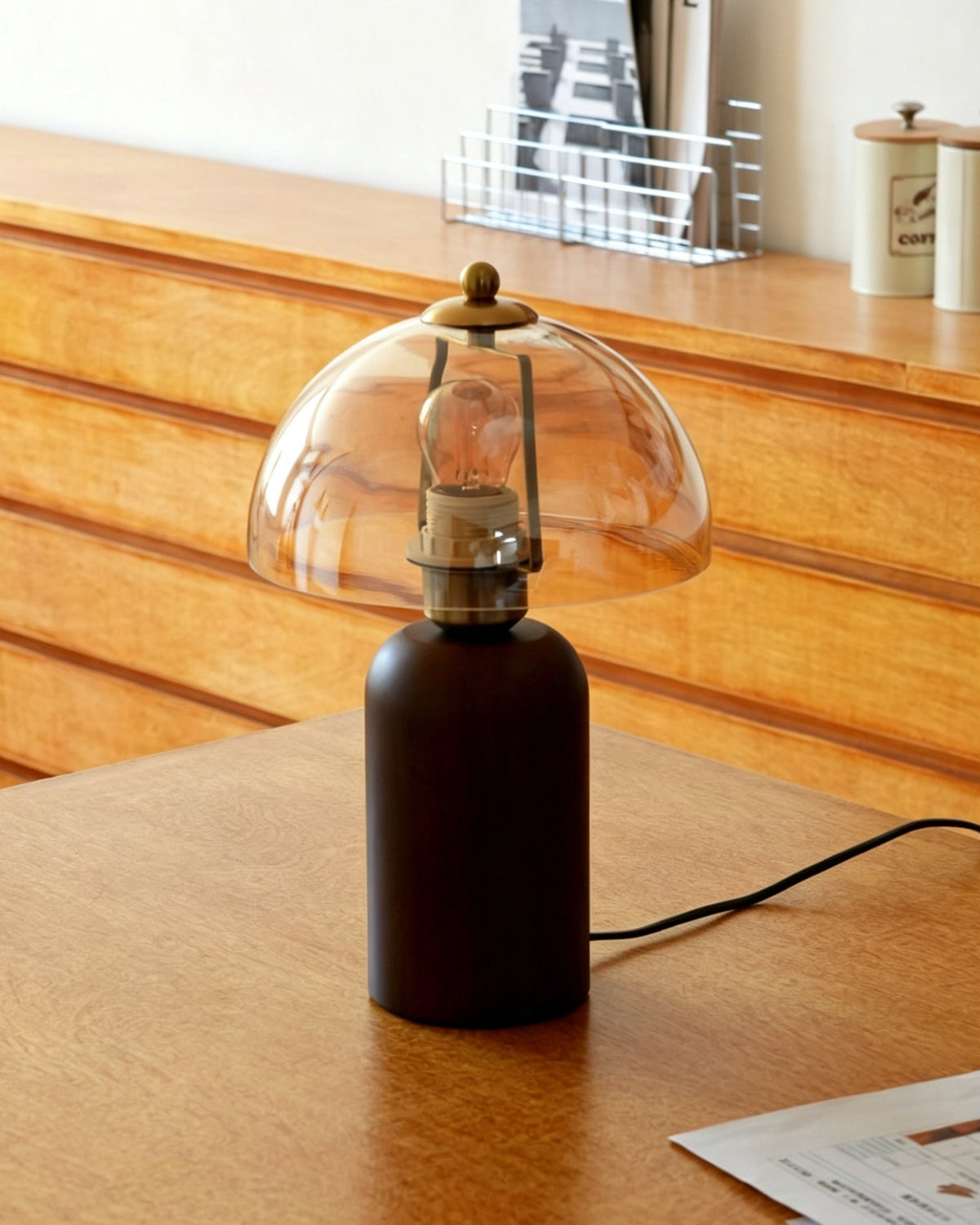The Disko Table Lamp with the light off, showing the contrast between the wood and glass.