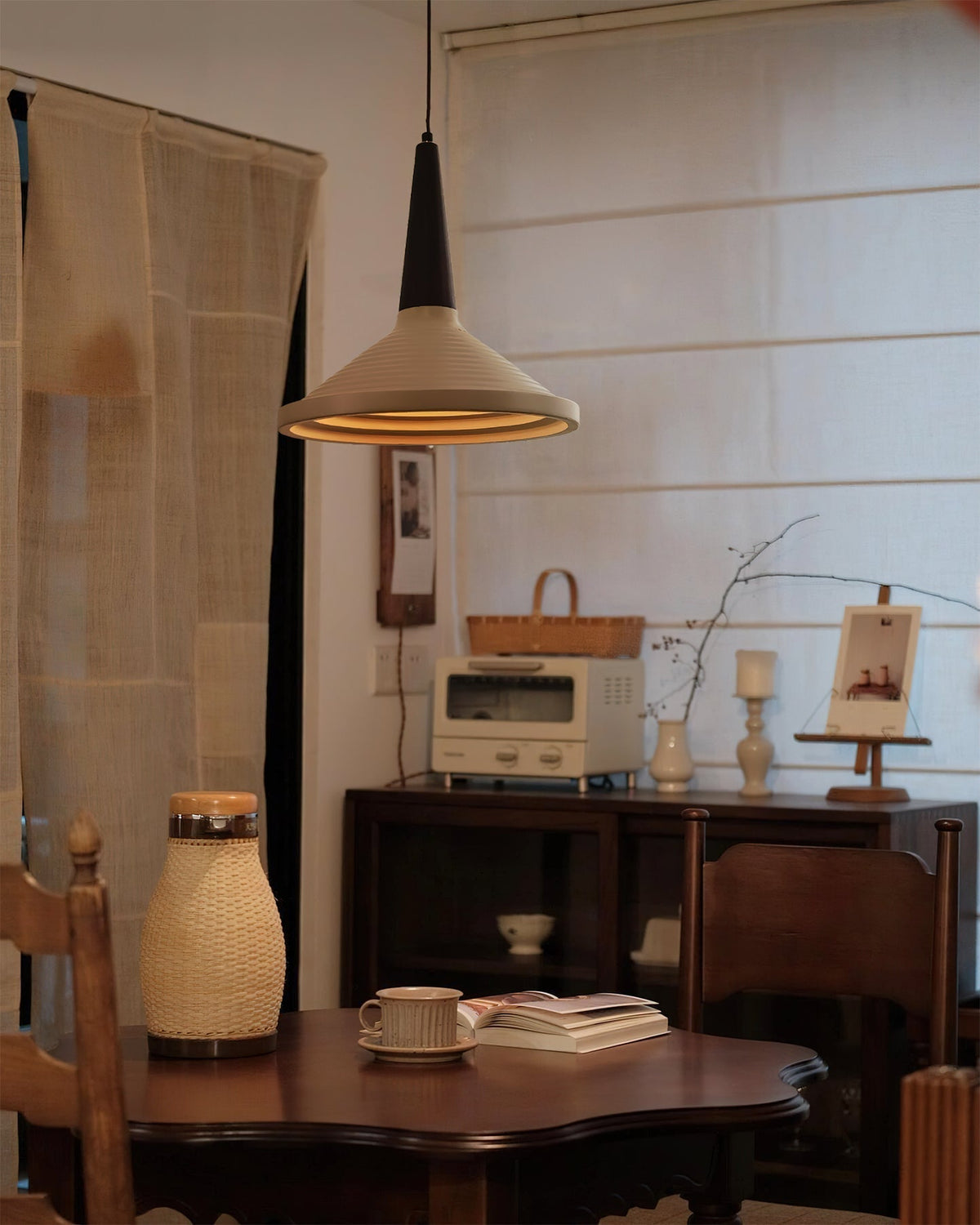Lifestyle view of the Doherty Pendant Light in a minimalist living room.