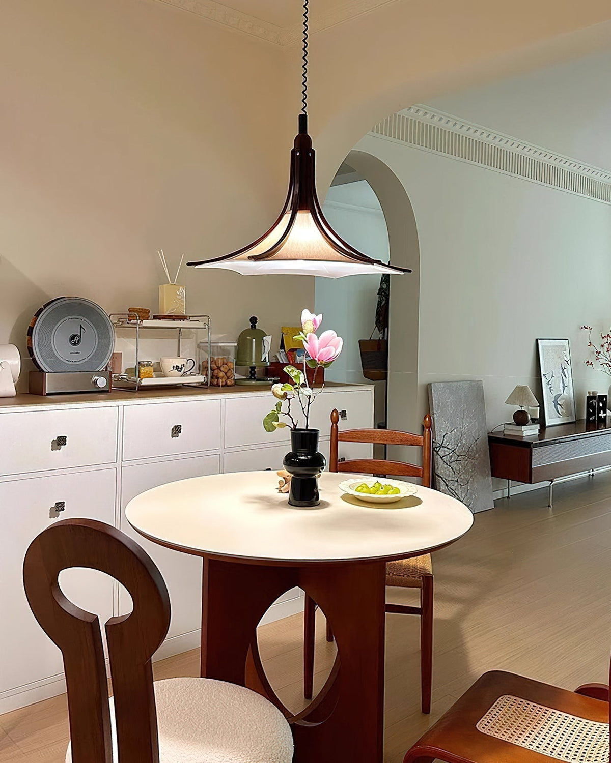 The pendant light in a bedroom setting, providing ambient light.