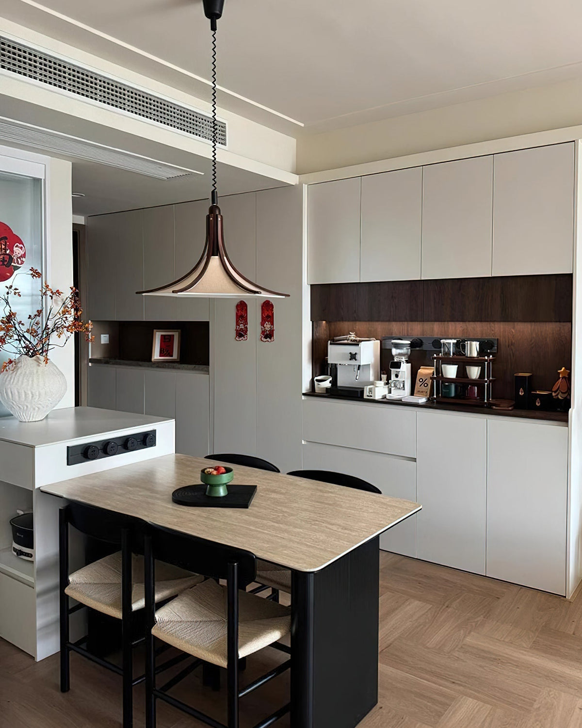 Lifestyle image of the Domus Pendant Light over a dining area.