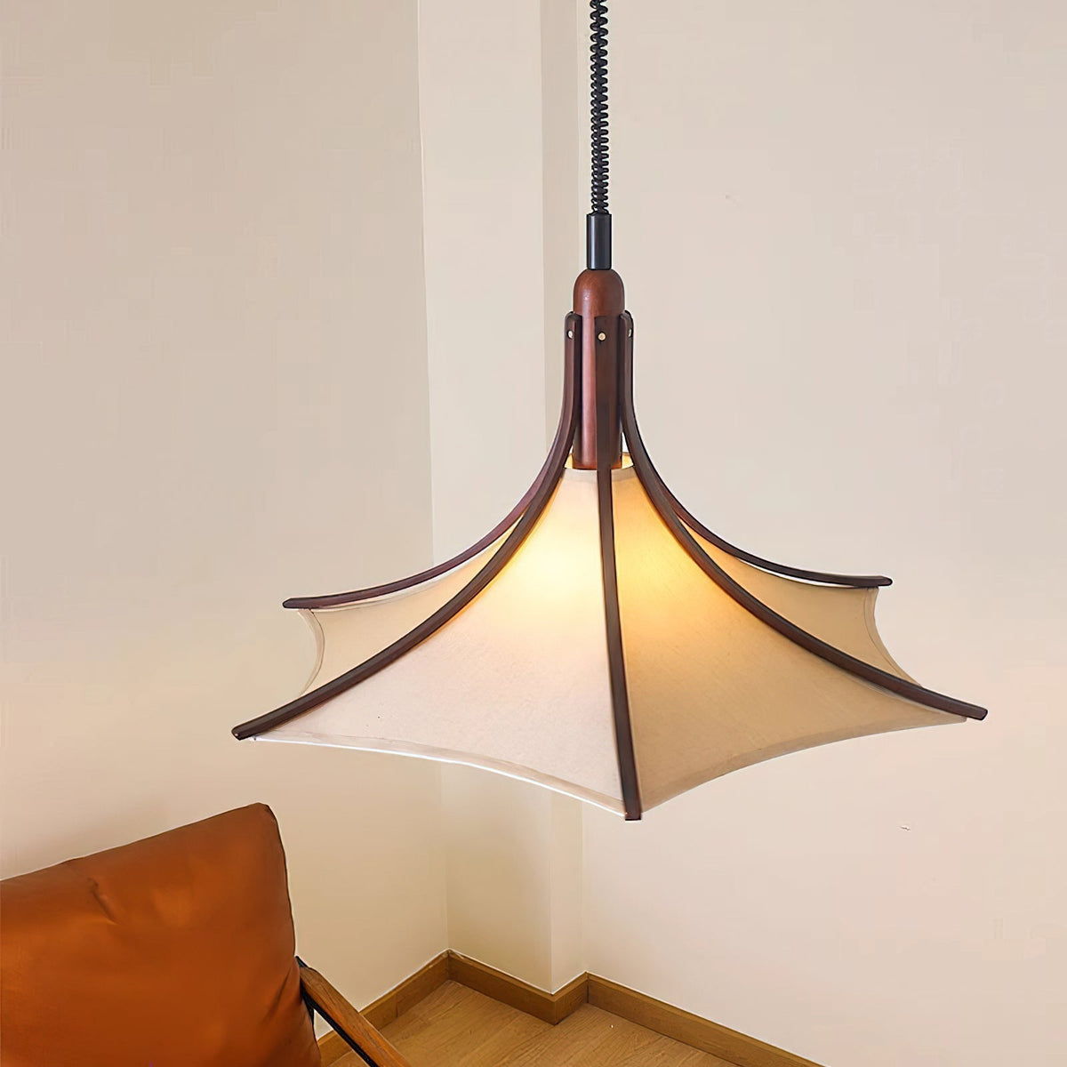 Domus Pendant Light shown hanging in a modern living room.