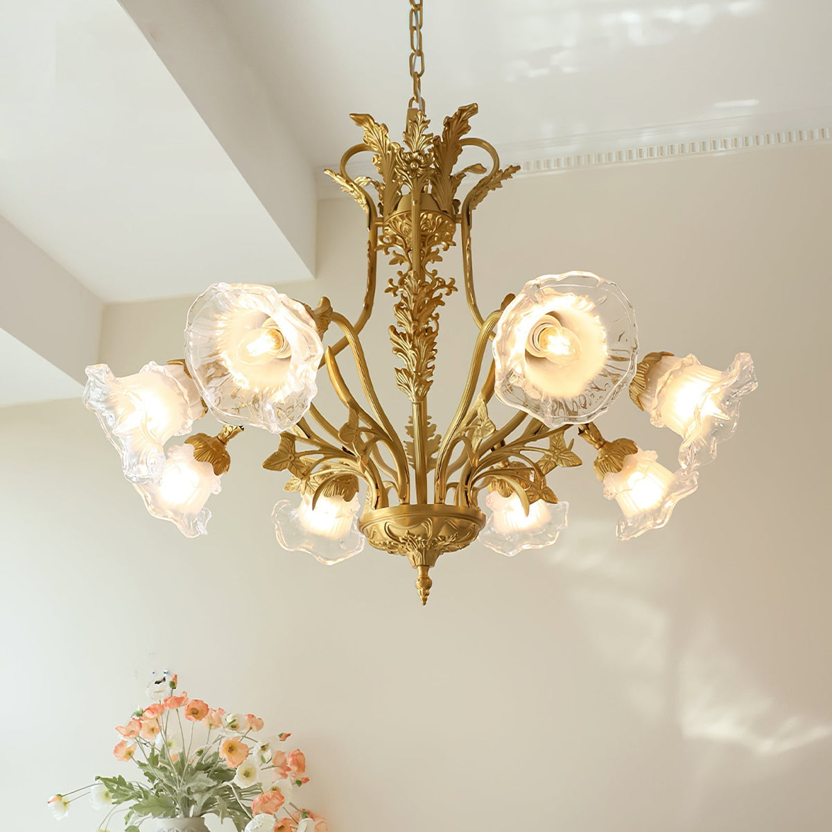 Close-up of the intricate floral details on the brass chandelier.