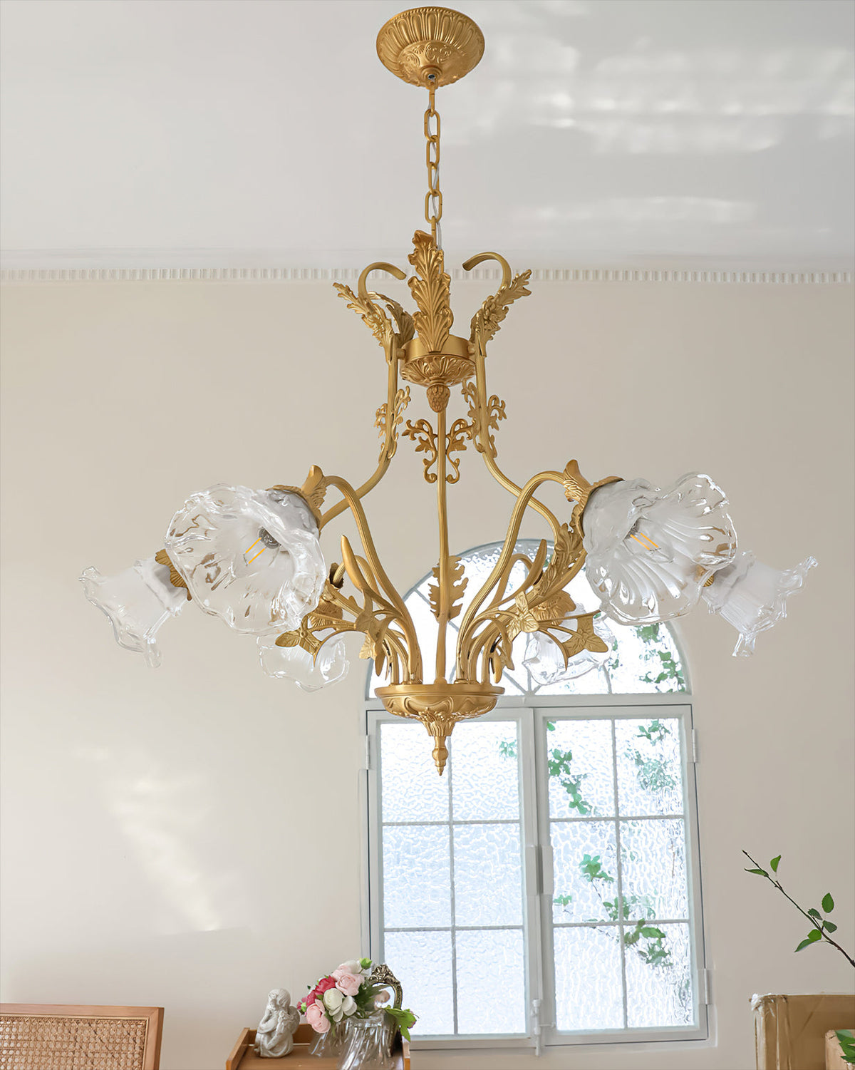 The chandelier illuminated, casting a warm glow in a living space.