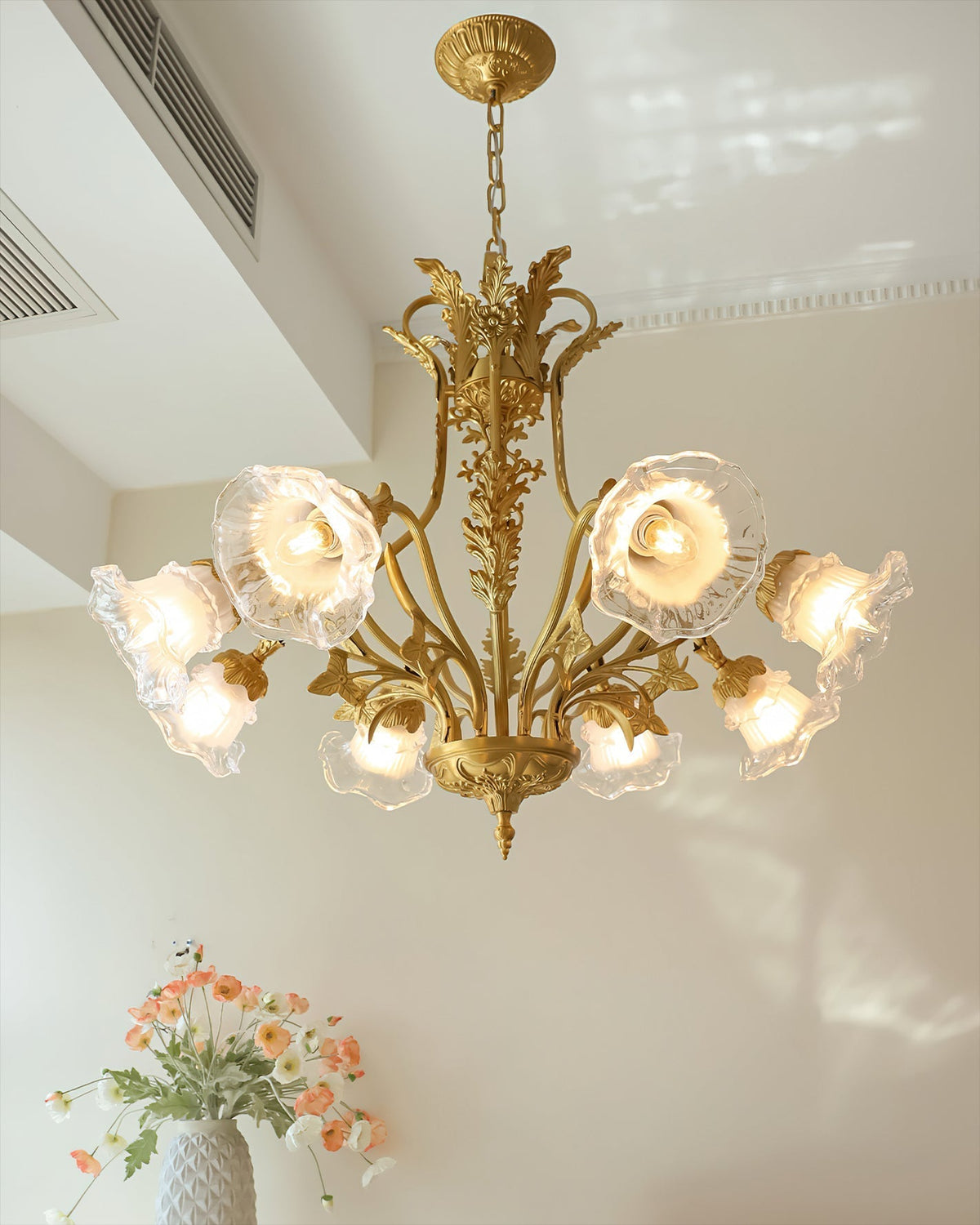 The polished brass finish of the chandelier's frame.