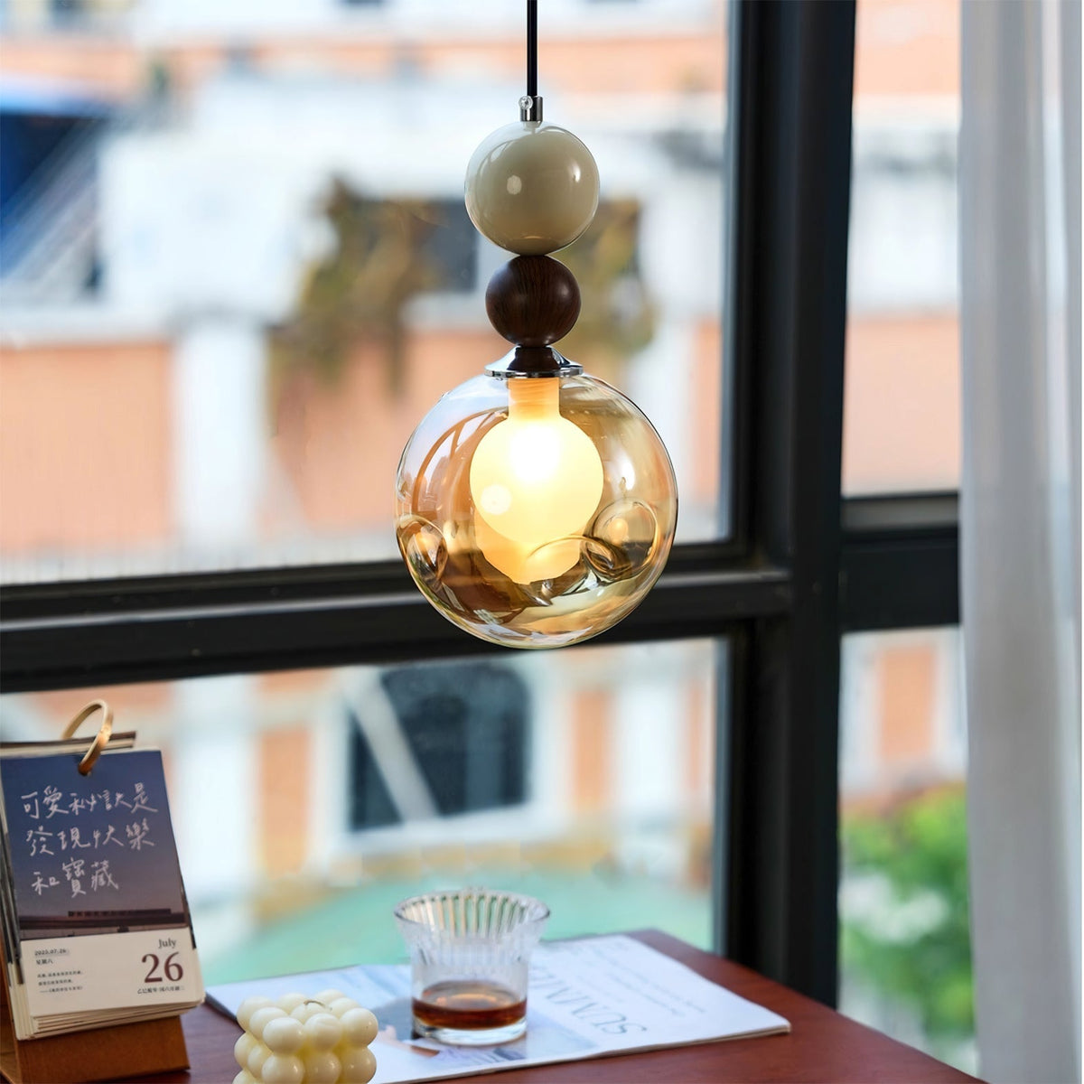 Close-up view of the Dot Pendant Light's glass orb and metal detail.