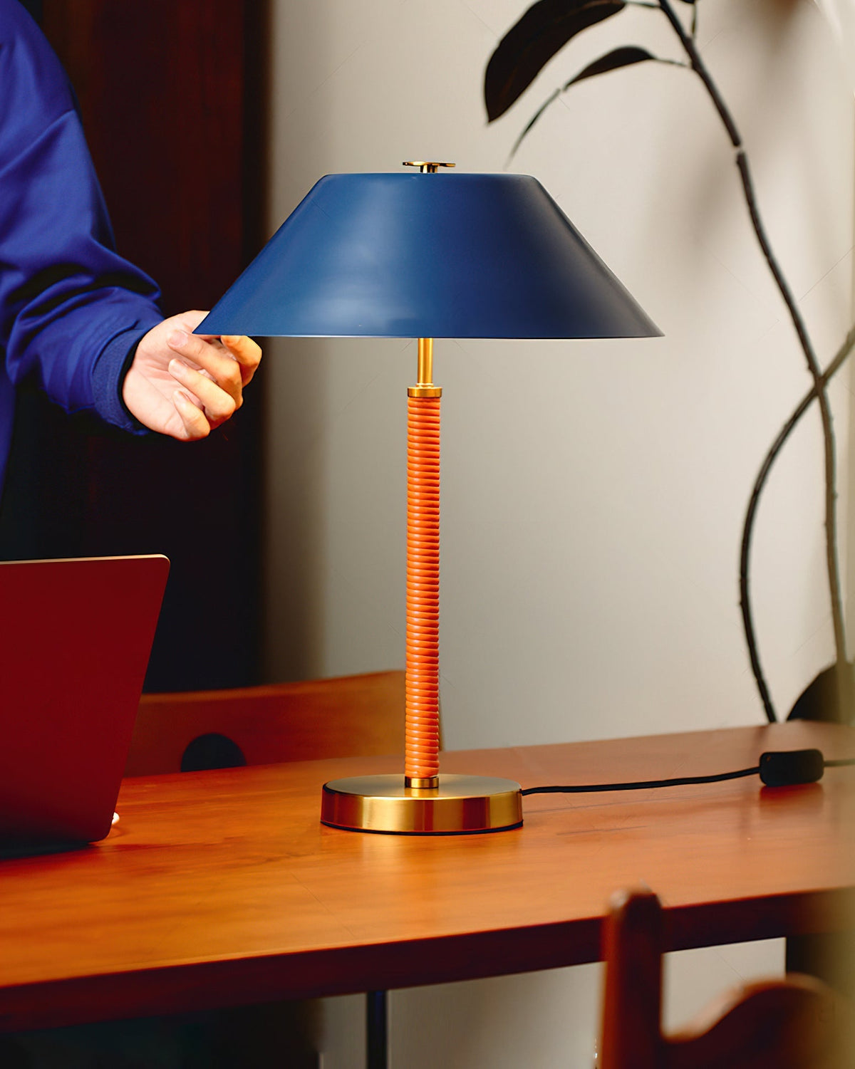 The Eave Table Lamp shown on a modern side table.