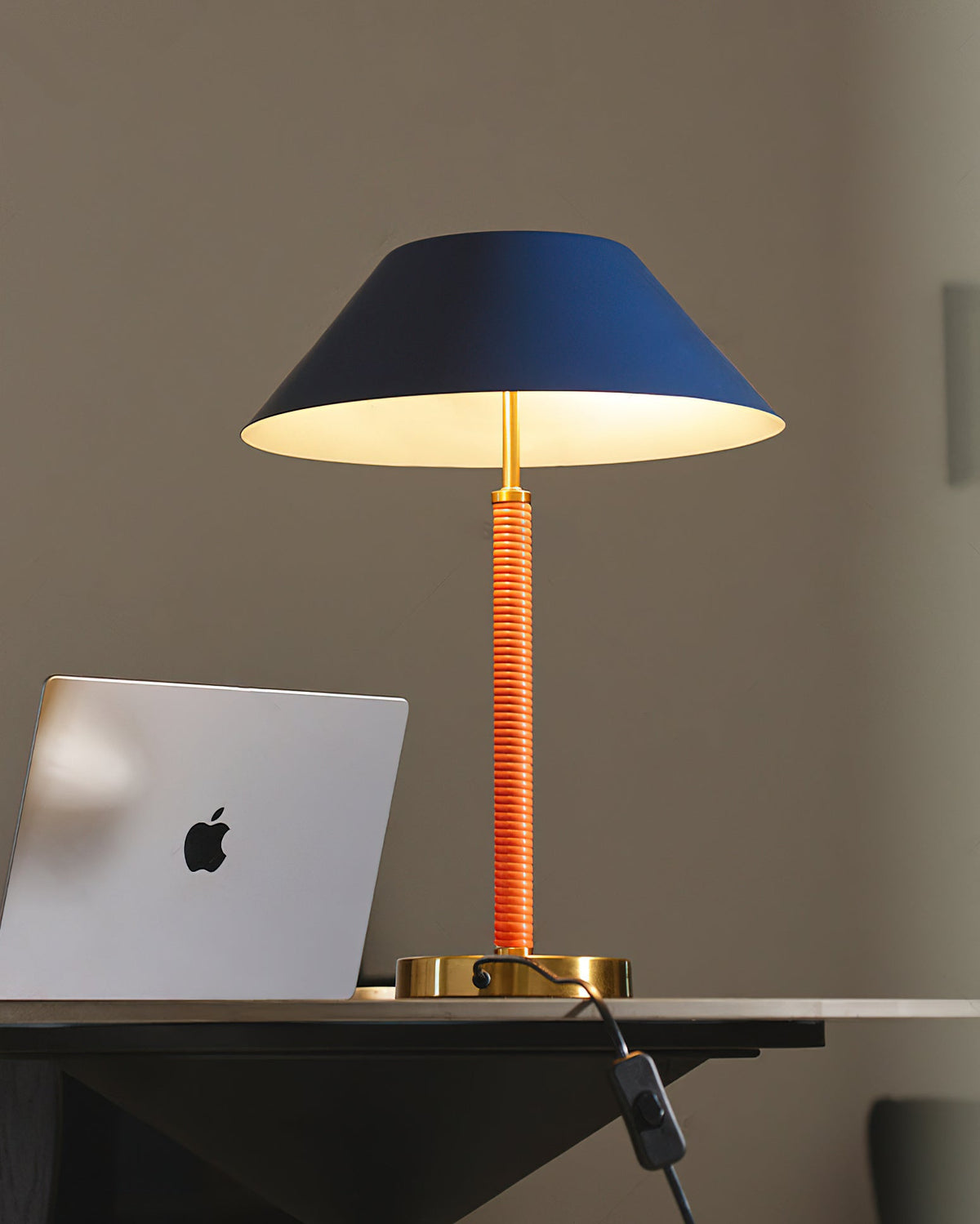 Detail shot of the lamp's golden base and blue shade.