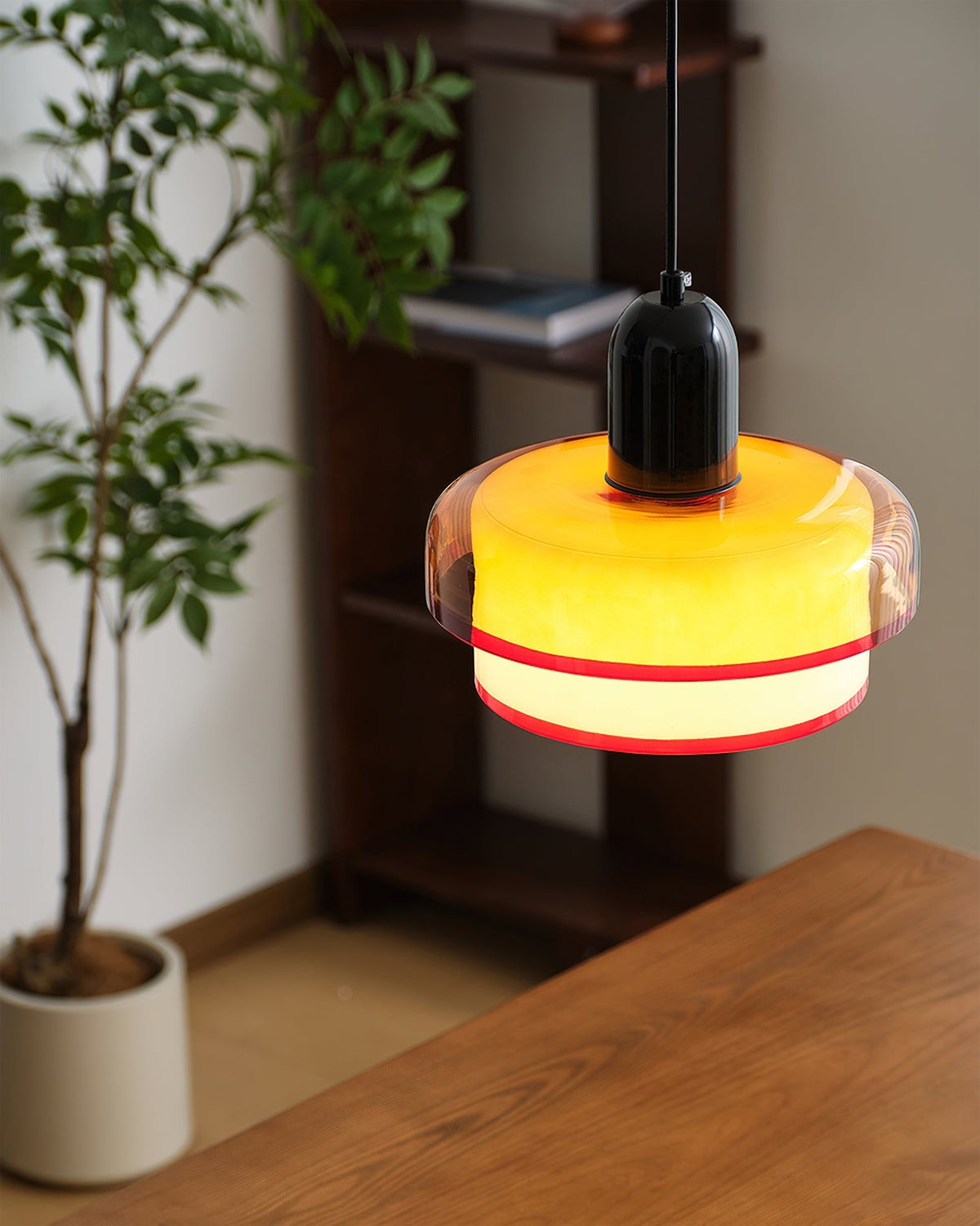 The Ebern Pendant Light illuminated, casting a warm glow.