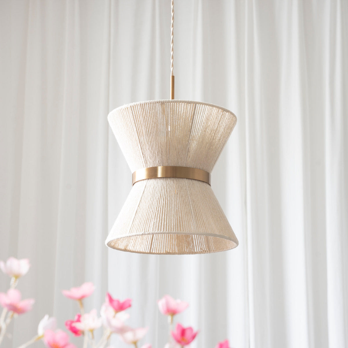 The intricate texture of the hand-woven cotton shade on the Elara pendant.