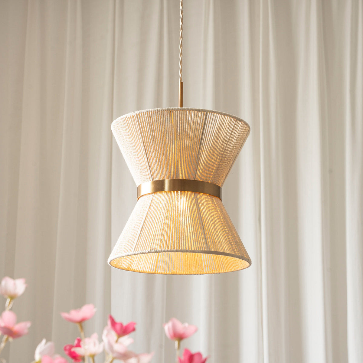 The Elara Woven Pendant Light styled in a modern, minimalist living room.