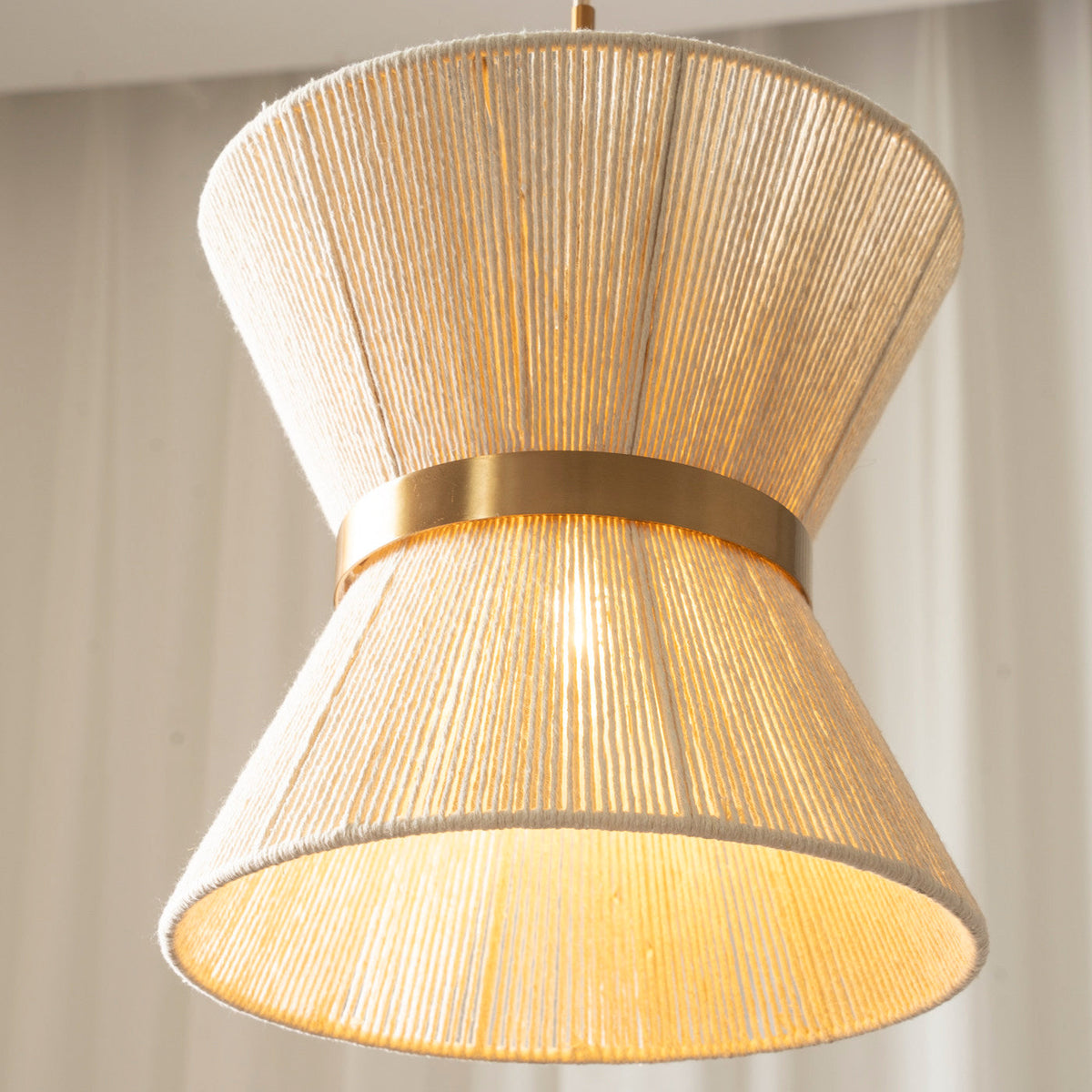Elara Woven Pendant Light with its white and gold finish complementing a neutral interior decor.
