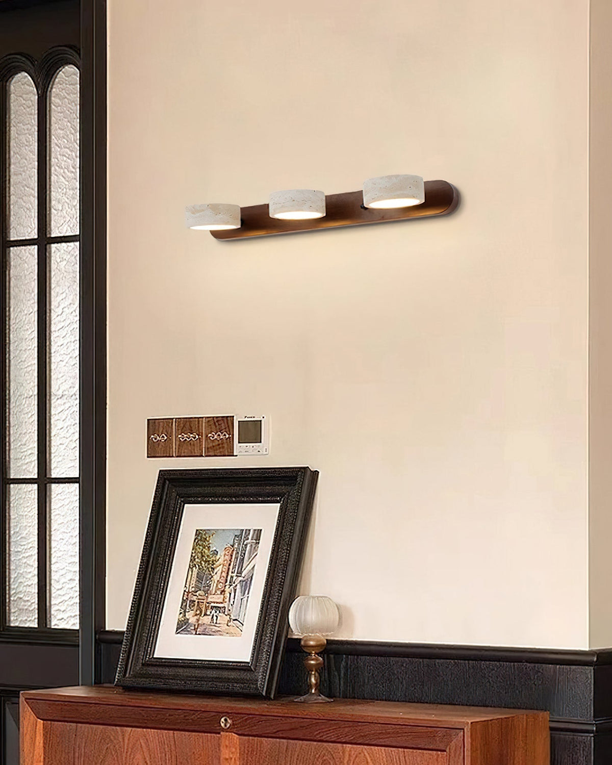 The 3-head Elias Travertine Wall Lamp, medium size option.