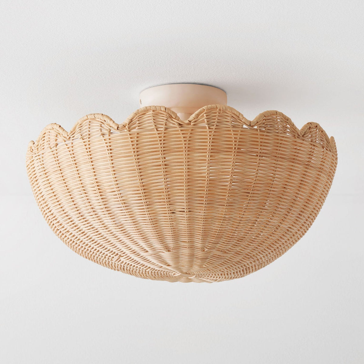 Angled view of the Elior ceiling light, highlighting its round, scalloped form.
