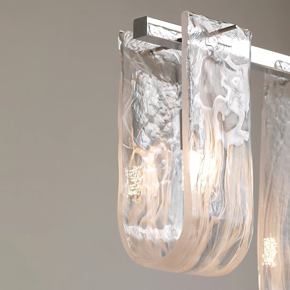 The sculpted glass pendants of the Fontaine Chandelier catching the light.