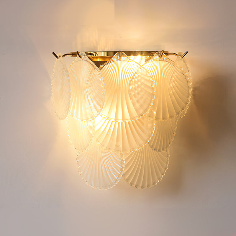 The Galerie Wall Lamp illuminated in a dark room, creating a warm glow.