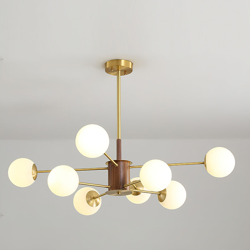 The chandelier illuminated in a dimly lit room to show its light pattern.