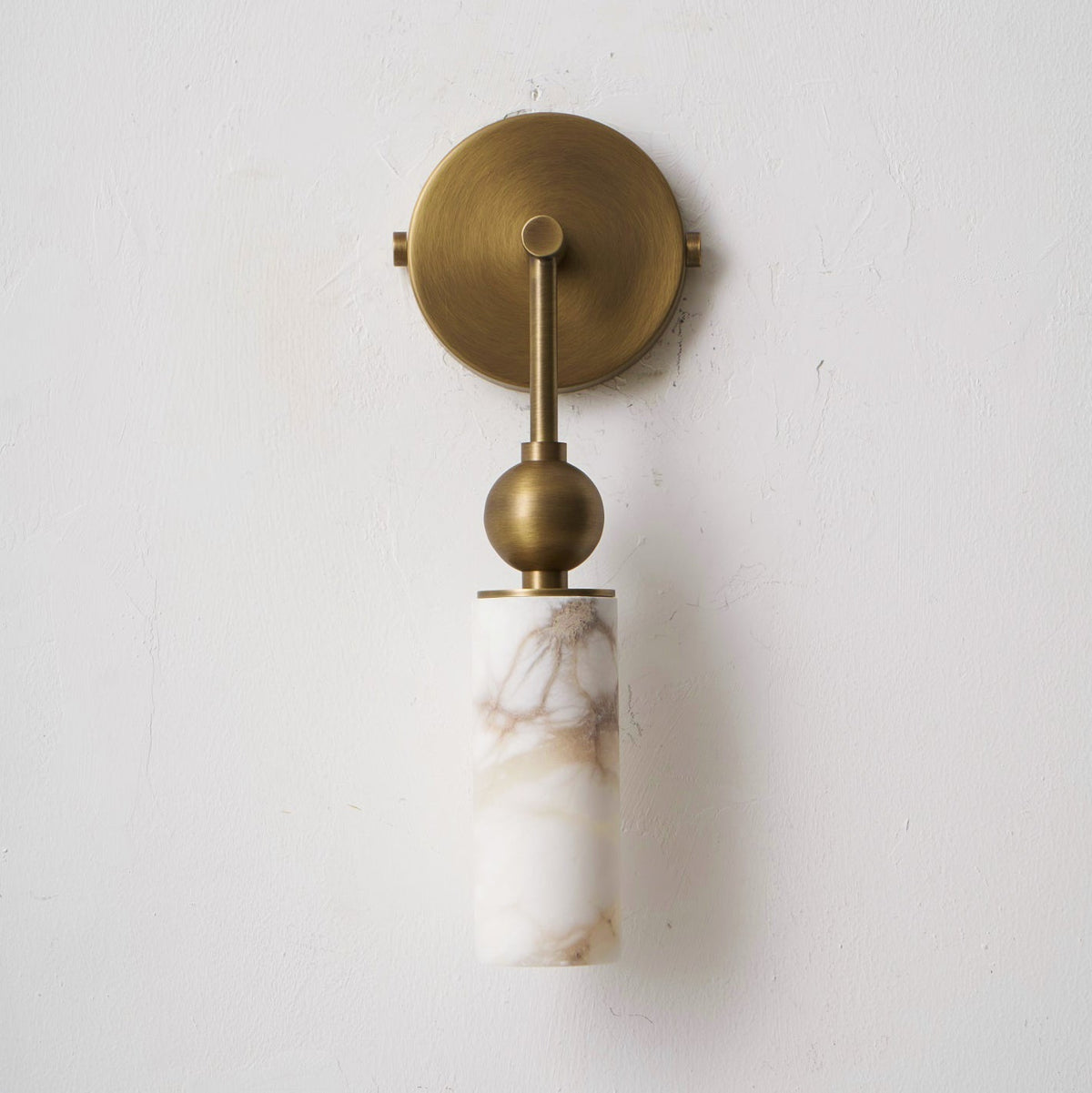 The geometric silhouette of the Metro Alabaster Wall Lamp.