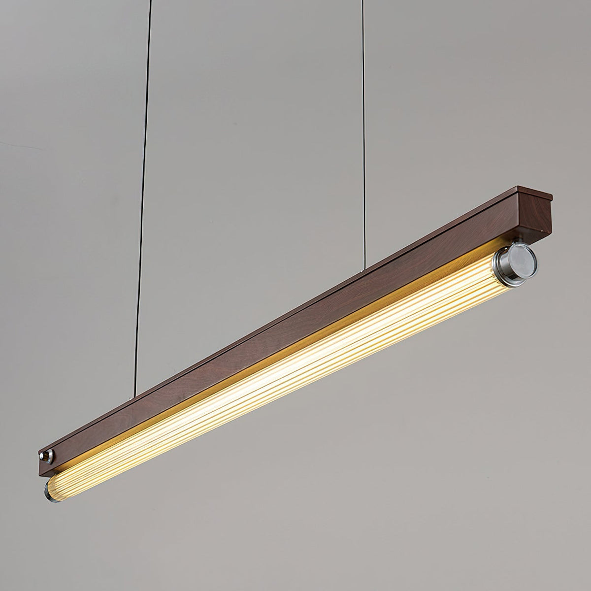 Close-up view of the Hiromi Chandelier's fluted acrylic diffuser emitting a warm glow.