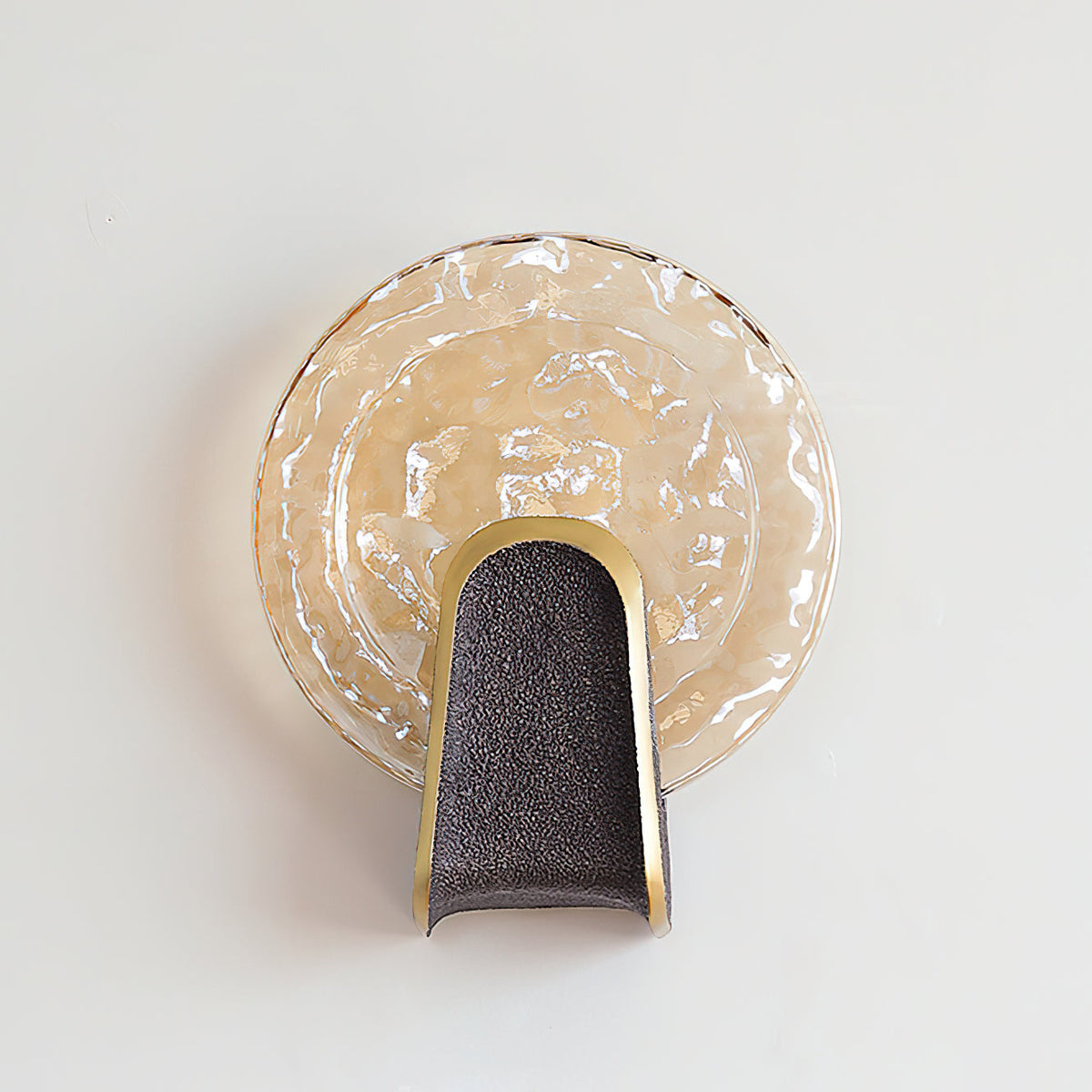 Ingot Wall Lamp with amber glass casting a warm light.