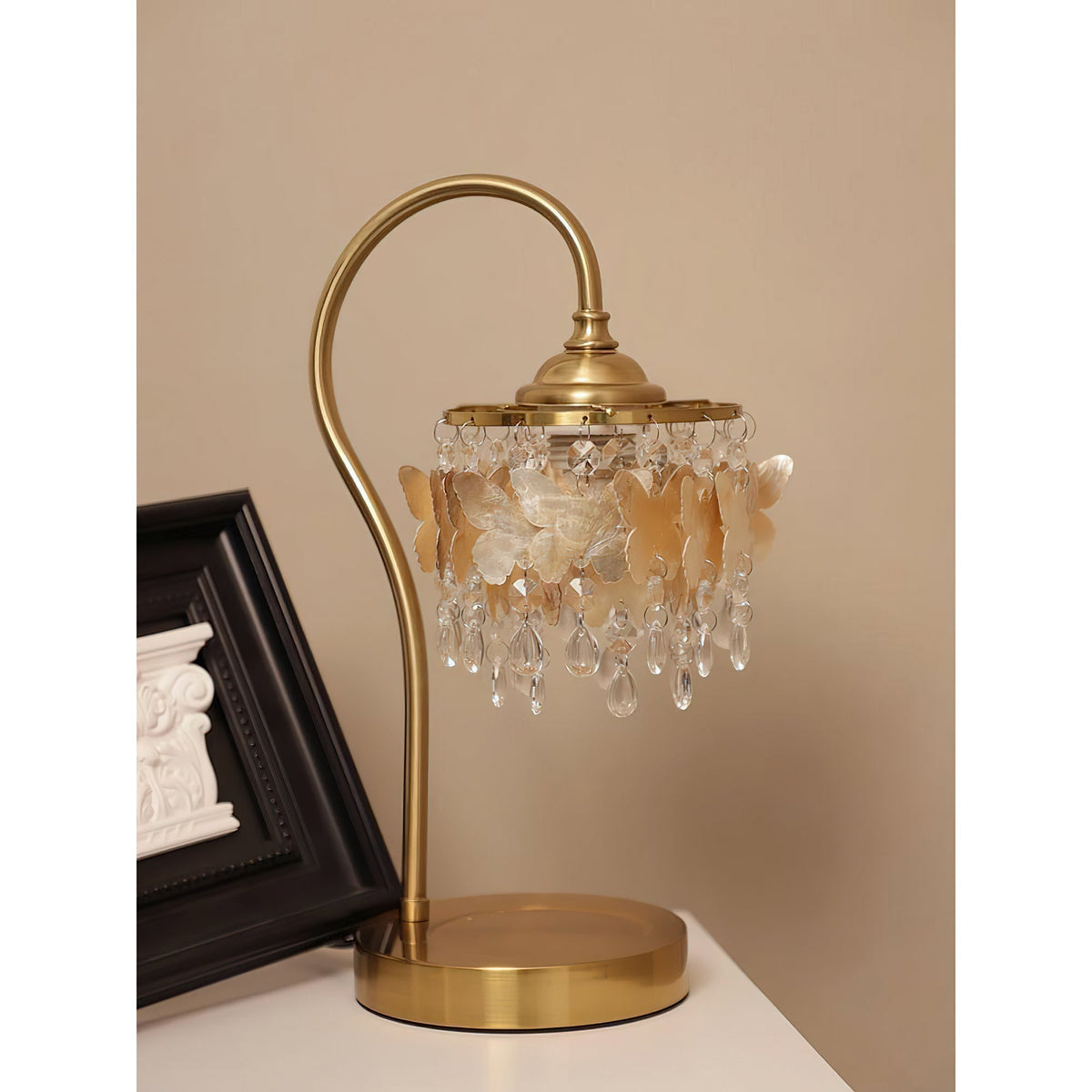 Close-up of the Jasinski Table Lamp's shell butterflies and crystal accents.