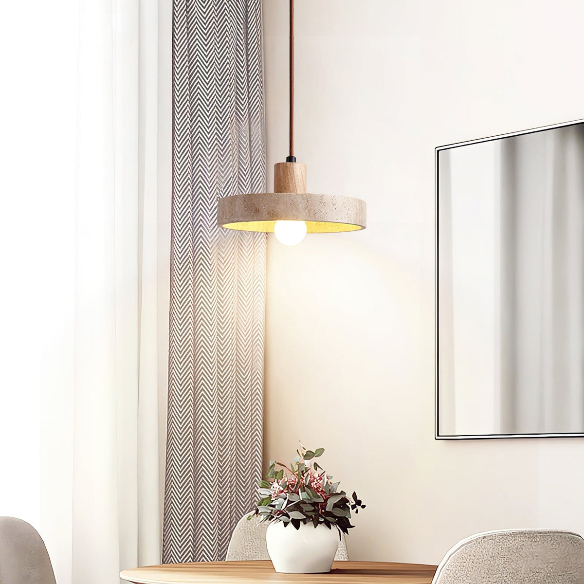 Lifestyle view of the Kairi Pendant Lamp in a minimalist living room.