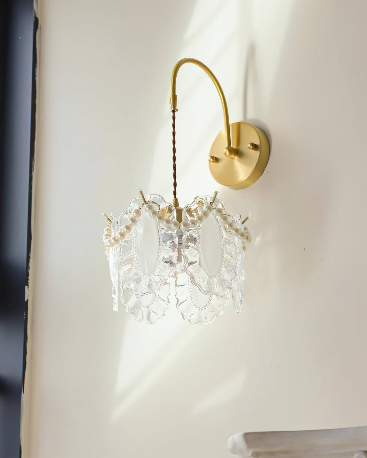 Kano Glass Wall Light illuminated, casting a warm and soft glow.