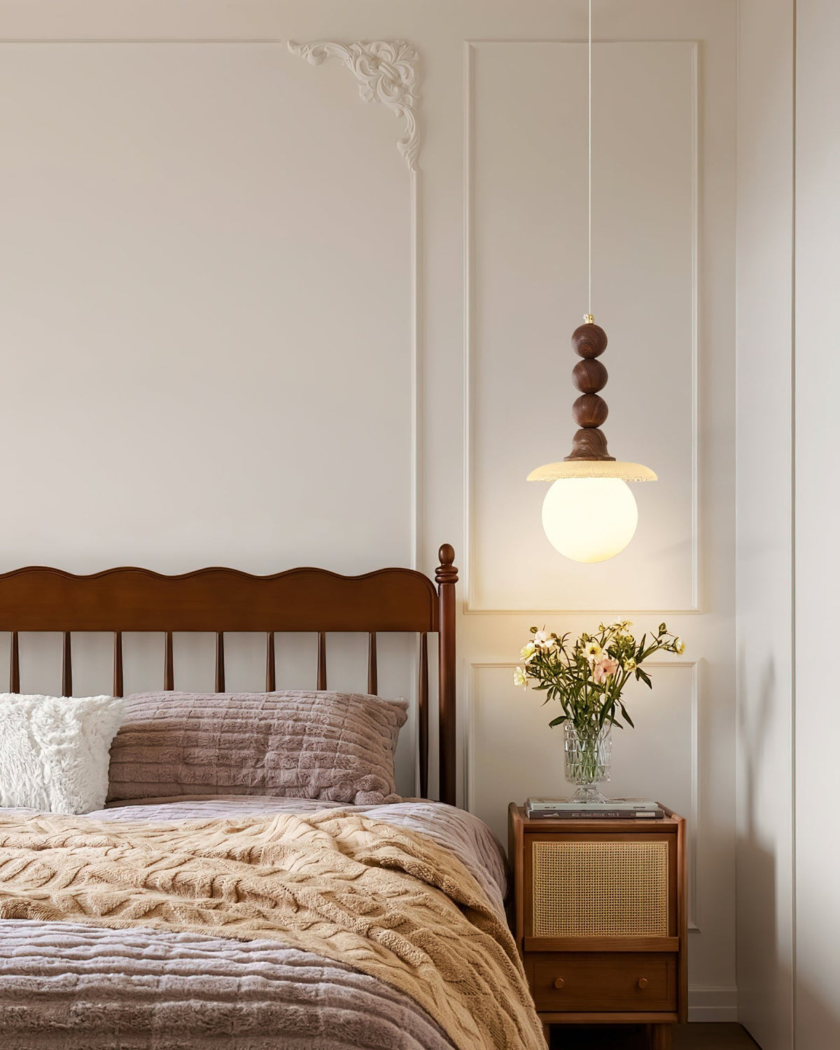 Detail shot of the walnut wood and gold metal top of the pendant lamp.
