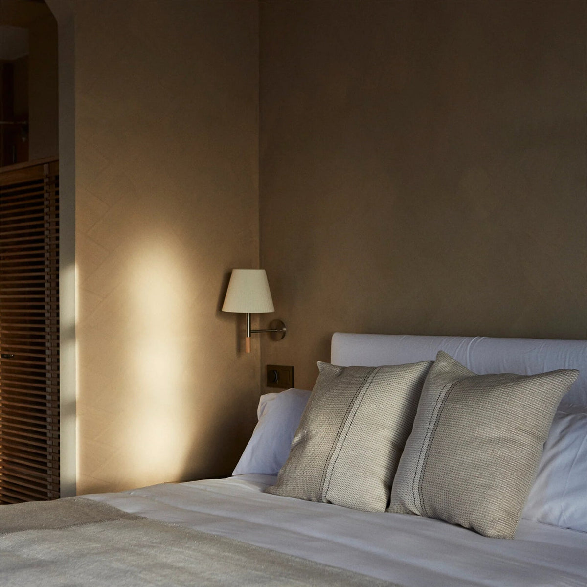 Kilkee Wall Lamp turned on, casting a warm and cozy glow.