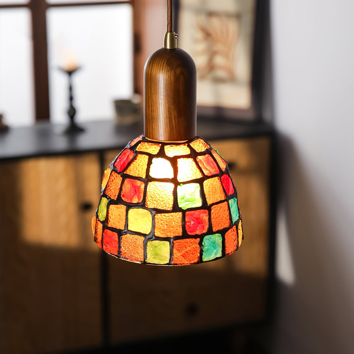 The mosaic glass shade of the Klima Pendant Light, lit up.