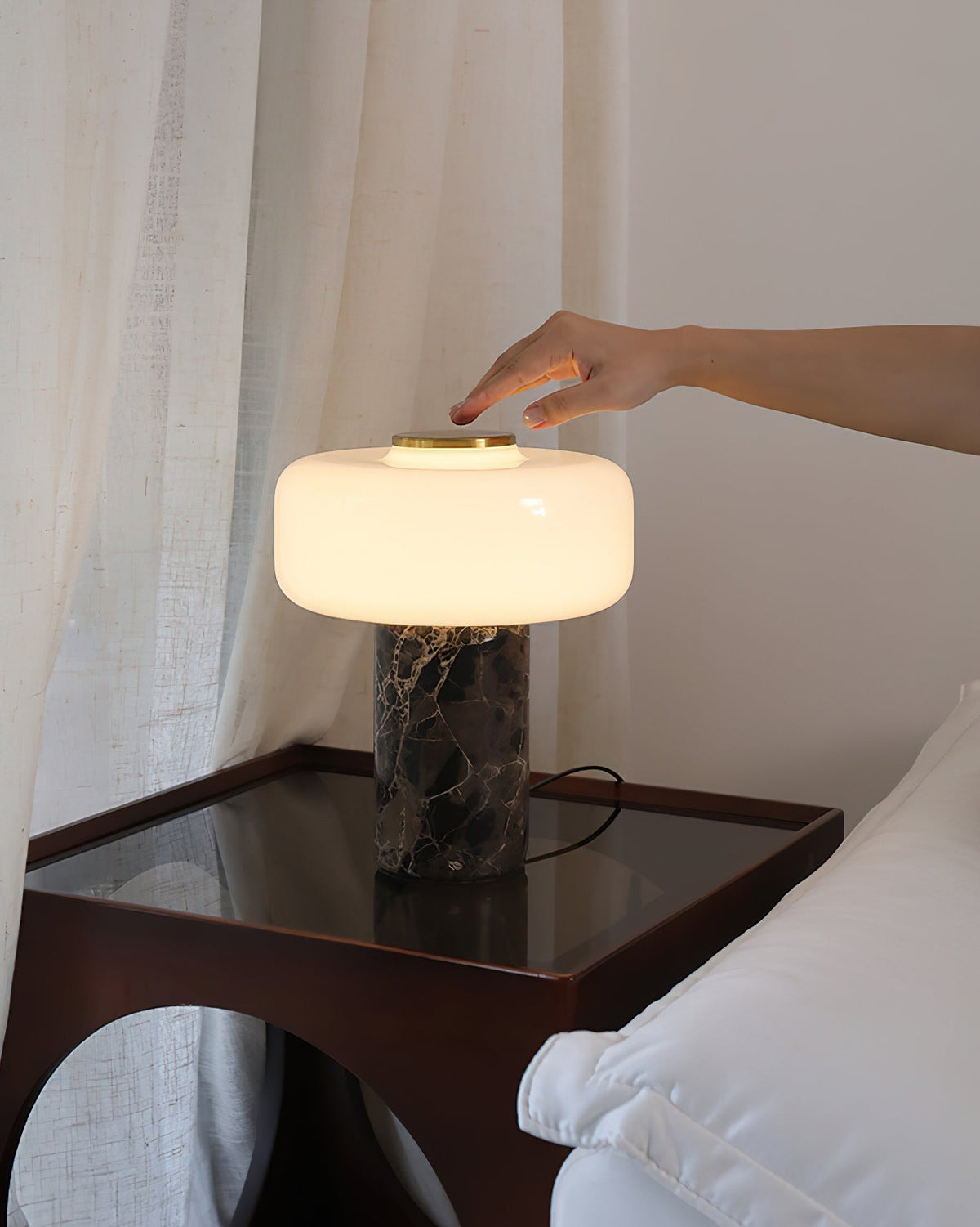 Close-up view of the dark, veined marble cylindrical base of the Lennox lamp.
