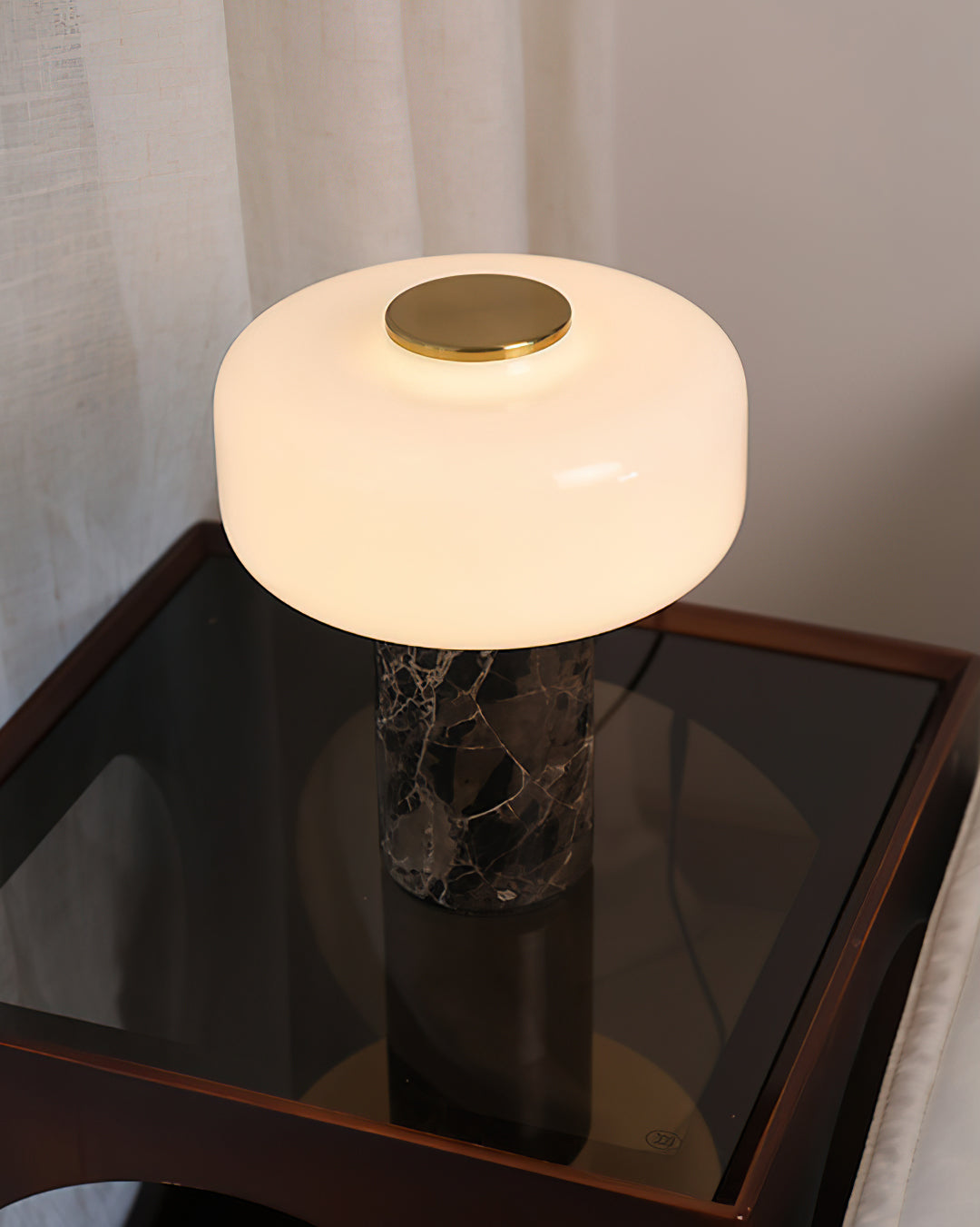 The lamp displayed on a bookshelf, adding an accent light to the decor.