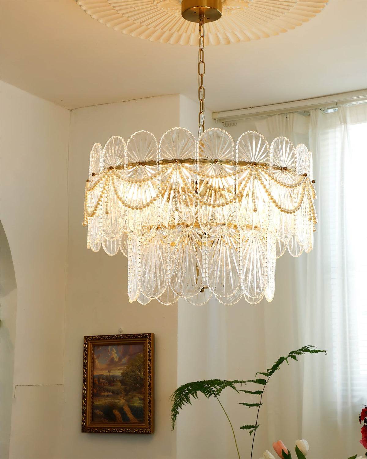 The 6-light version of the Leon Chandelier hanging in a living room.