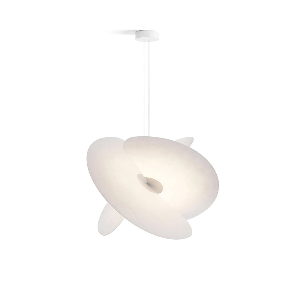 Levante Pendant Light with sculptural silk panels hanging in a modern living room.