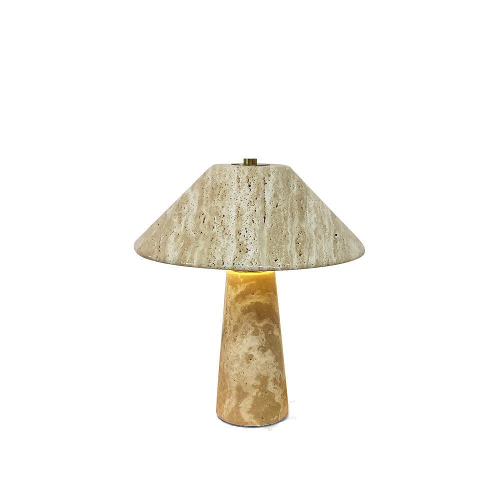 The porous texture of the travertine base of the Lydia Table Lamp.