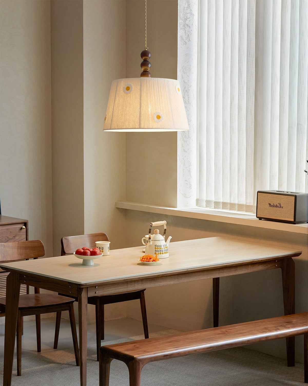 The pendant light illuminating a dining area with a warm glow.