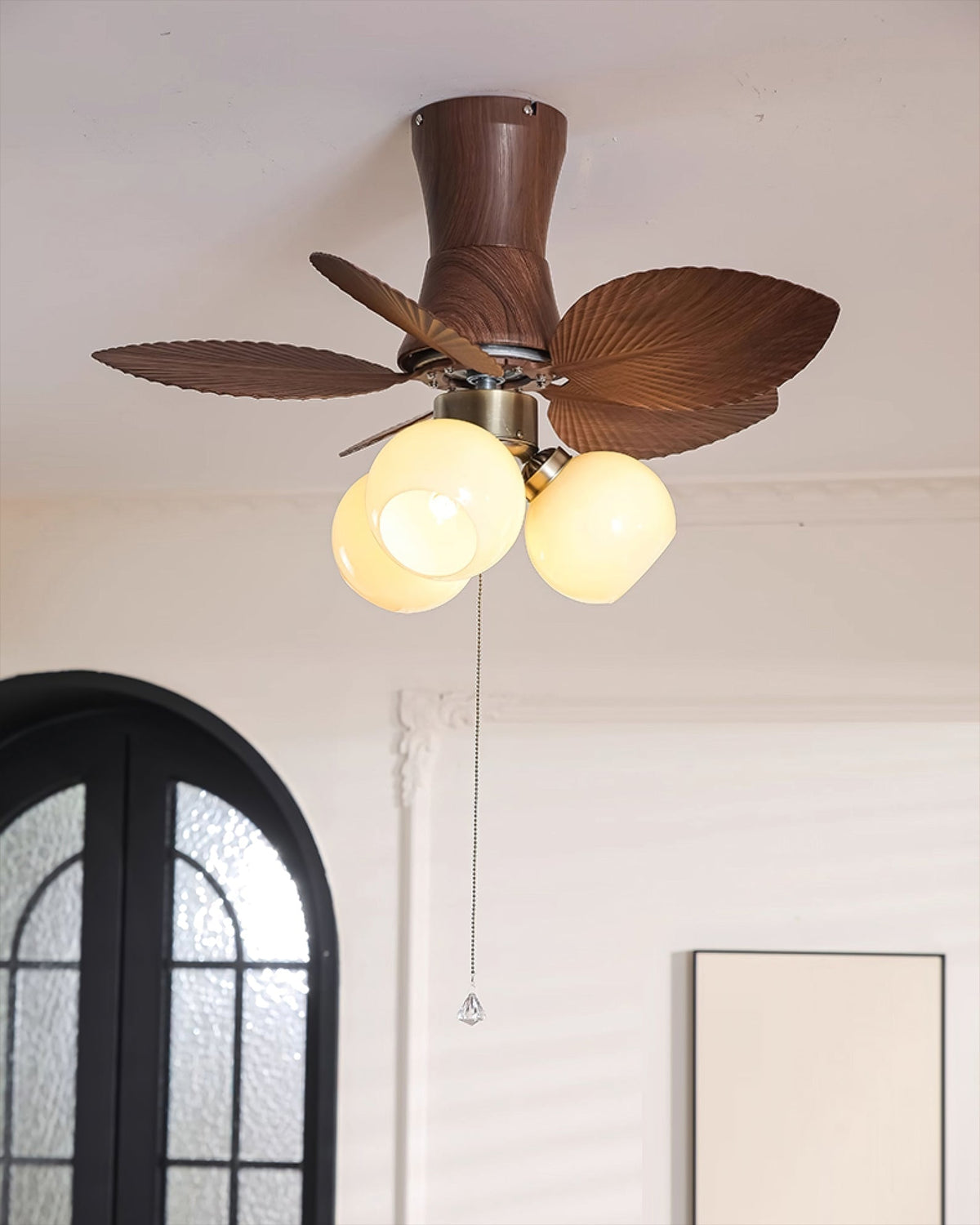 Malibu Ceiling Fan Light in a bedroom with tropical decor.