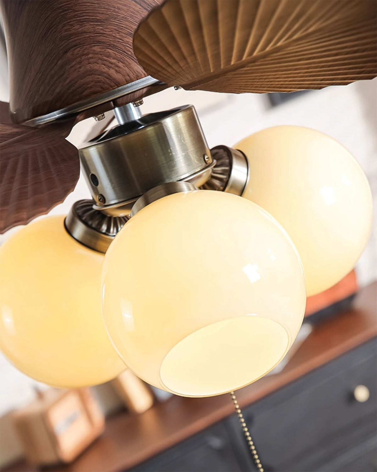 Malibu Ceiling Fan Light in Walnut finish, fan blades in motion.