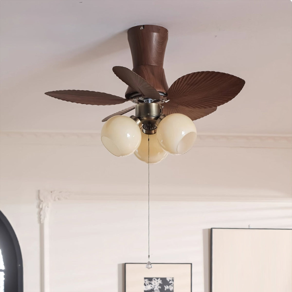 The Brushed Champagne finish Malibu fan in a minimalist room.