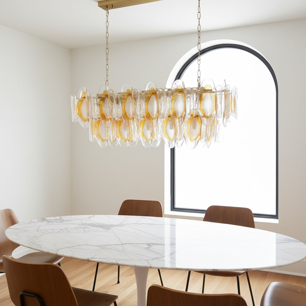 The Marrina Chandelier illuminated in a dark room, casting a warm glow.