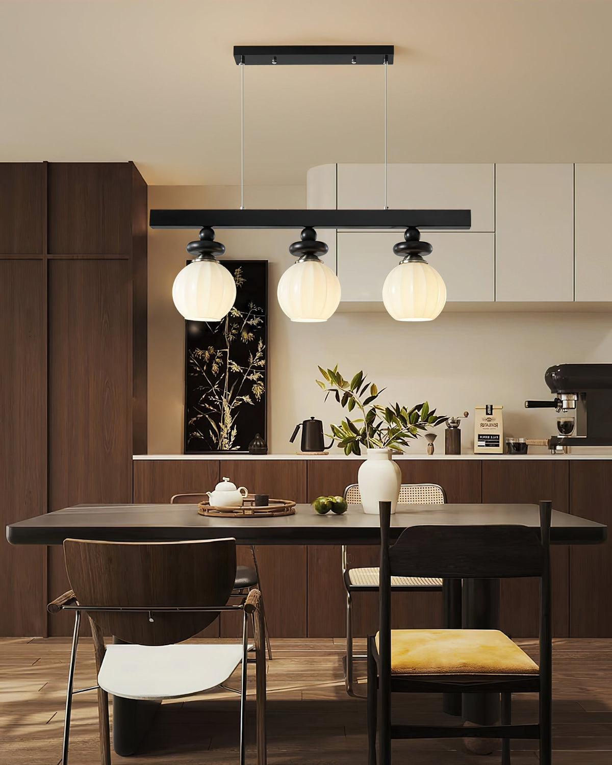 The 4-light linear Maru Pendant Light shown above a long dining table.