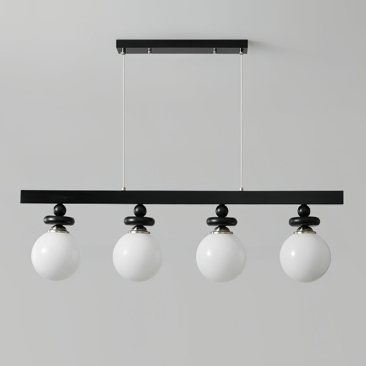 The 3-light Maru Pendant fixture against a clean, white wall.