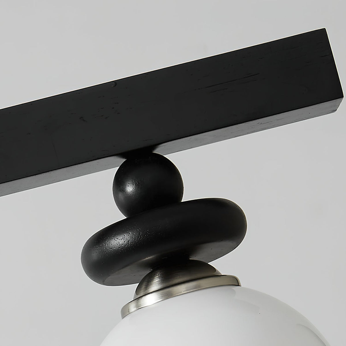 Close-up on the connection point of the glass globe to the metal frame.