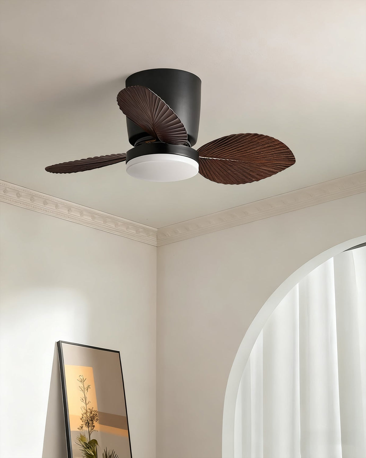 The wood finish Melorie fan viewed from a distance in a large room.