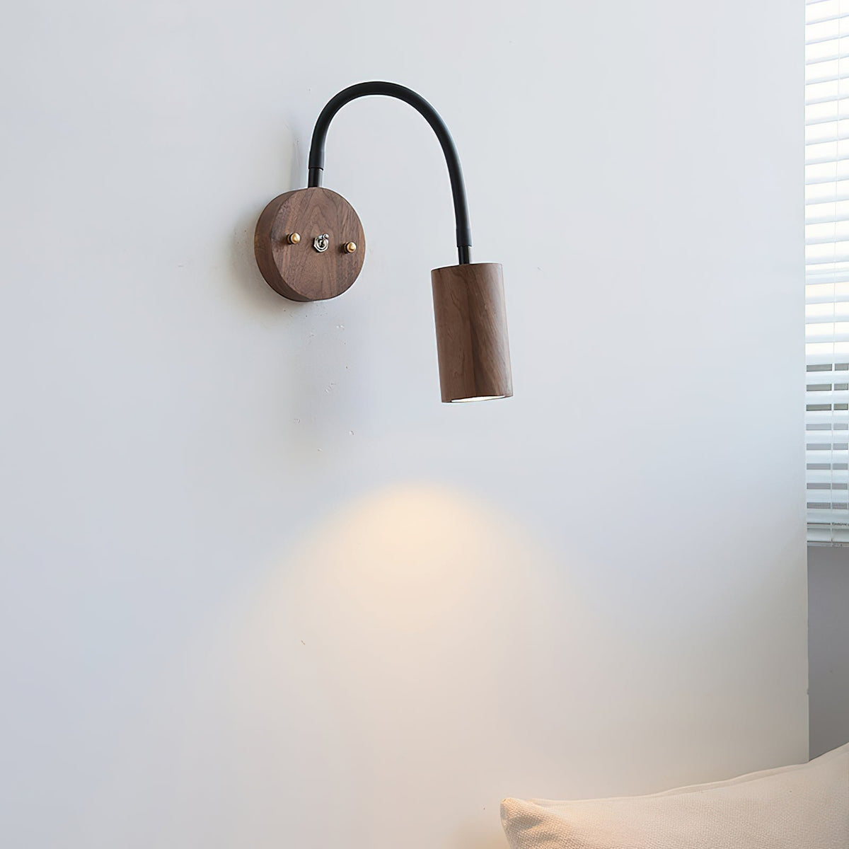 Micro Wall Lamp in walnut color finish against a light wall.