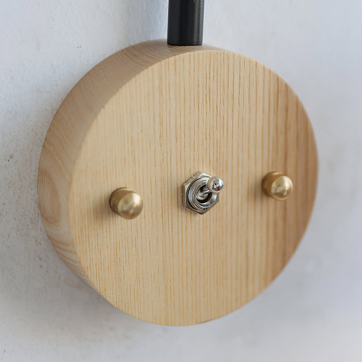 Another view of the lamp installed on a textured, dark wall.