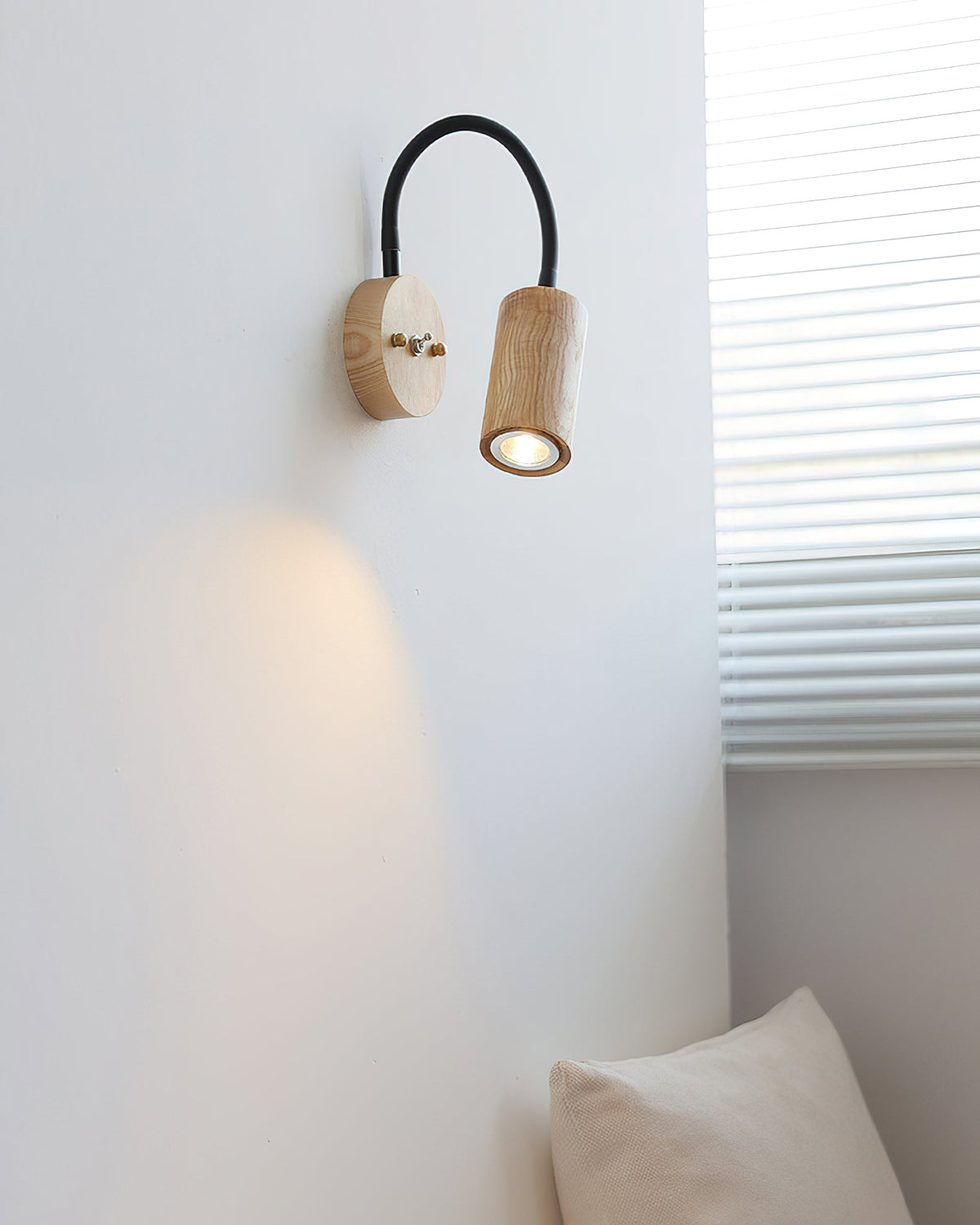 The wall lamp installed in a modern bedroom setting above a nightstand.