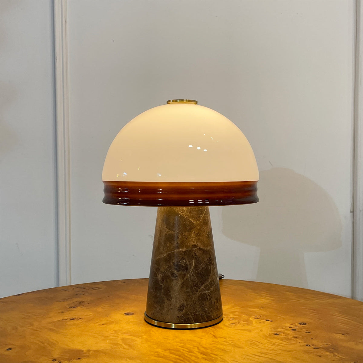 The rechargeable Milano Table Lamp with its included USB charging cable.