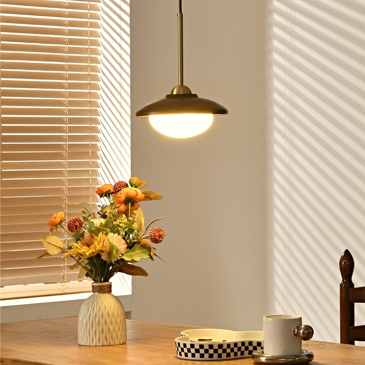Close-up view of the frosted glass globe and wood detail on the Milivia Pendant Light.